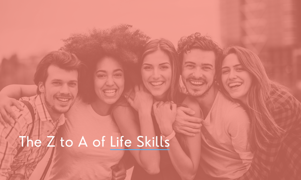 A group of five friends, three men and two women, all huddled together to get a photo taken of their friendships. They are all smiling and looking straight at the camera.