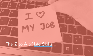 A laptop keyboard with a post it note saying I love my job on it.