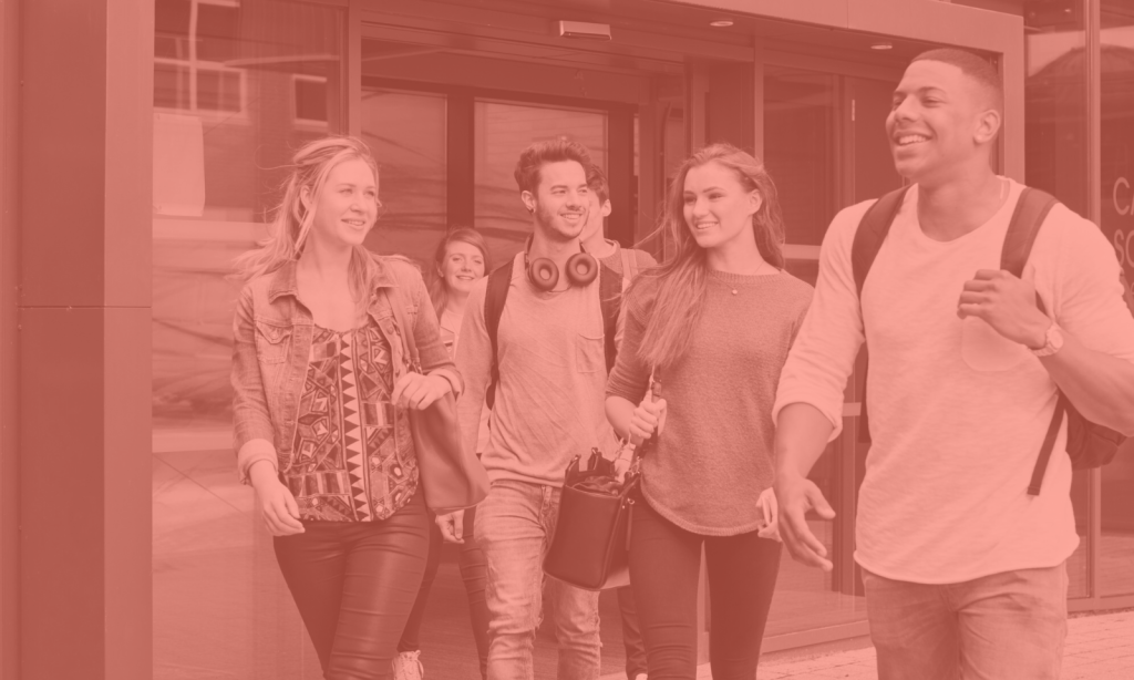 Group of students walking together. They are laughing, smiling and chatting as they stroll.