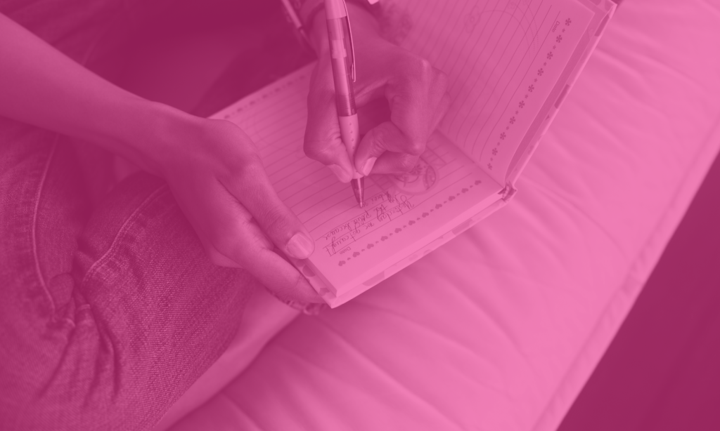 Woman journaling in her bed