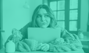 A woman leaning on a laptop, looking away confused.